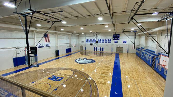Gym floor featuring blue details and eagle logo