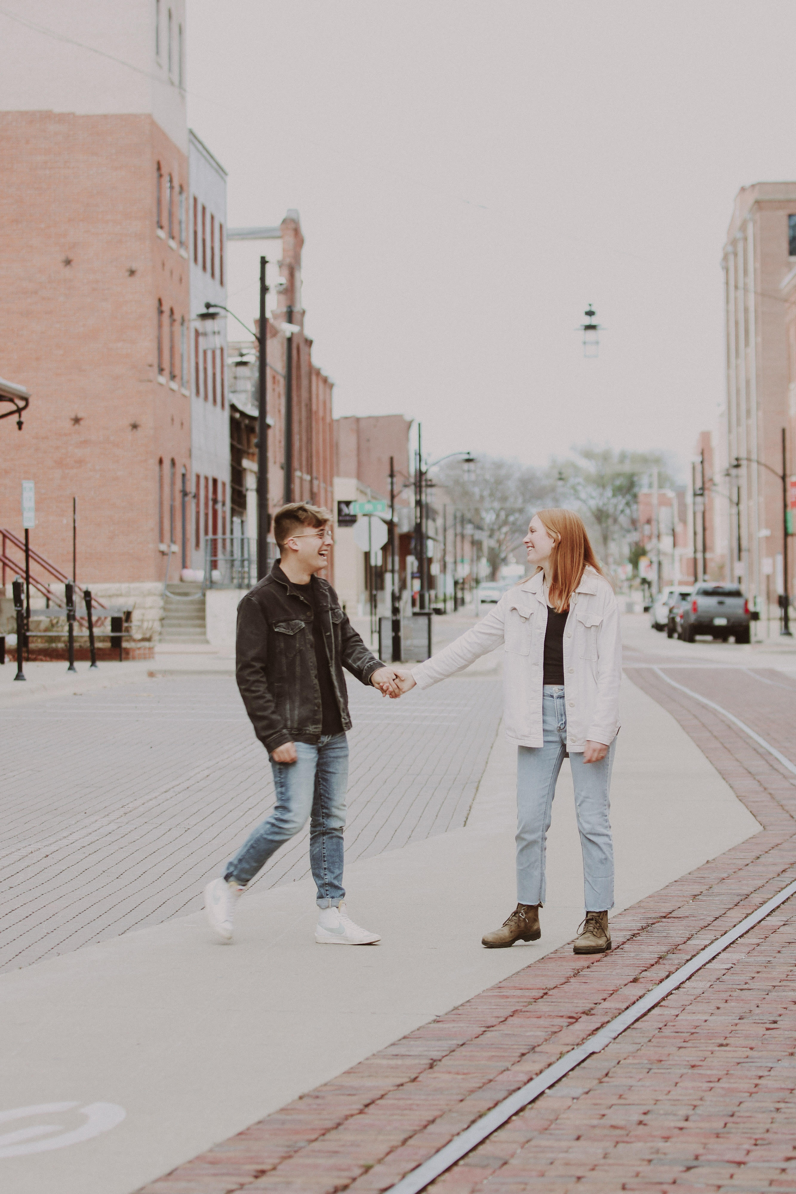 Couple standing in city street holding hands