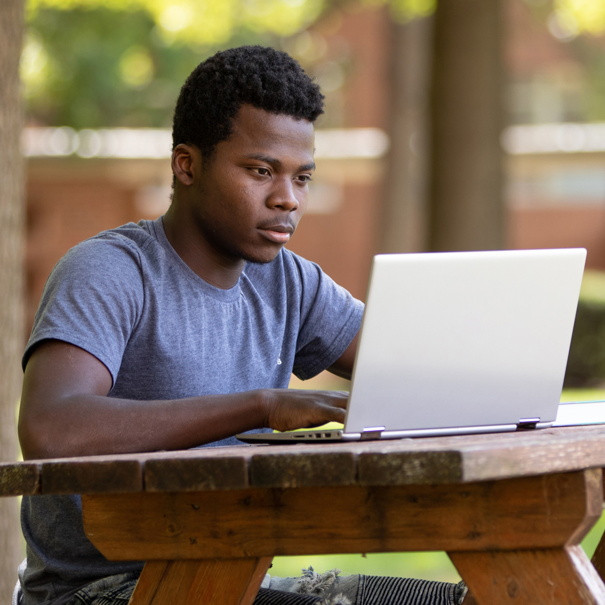 Student taking online courses on a laptop