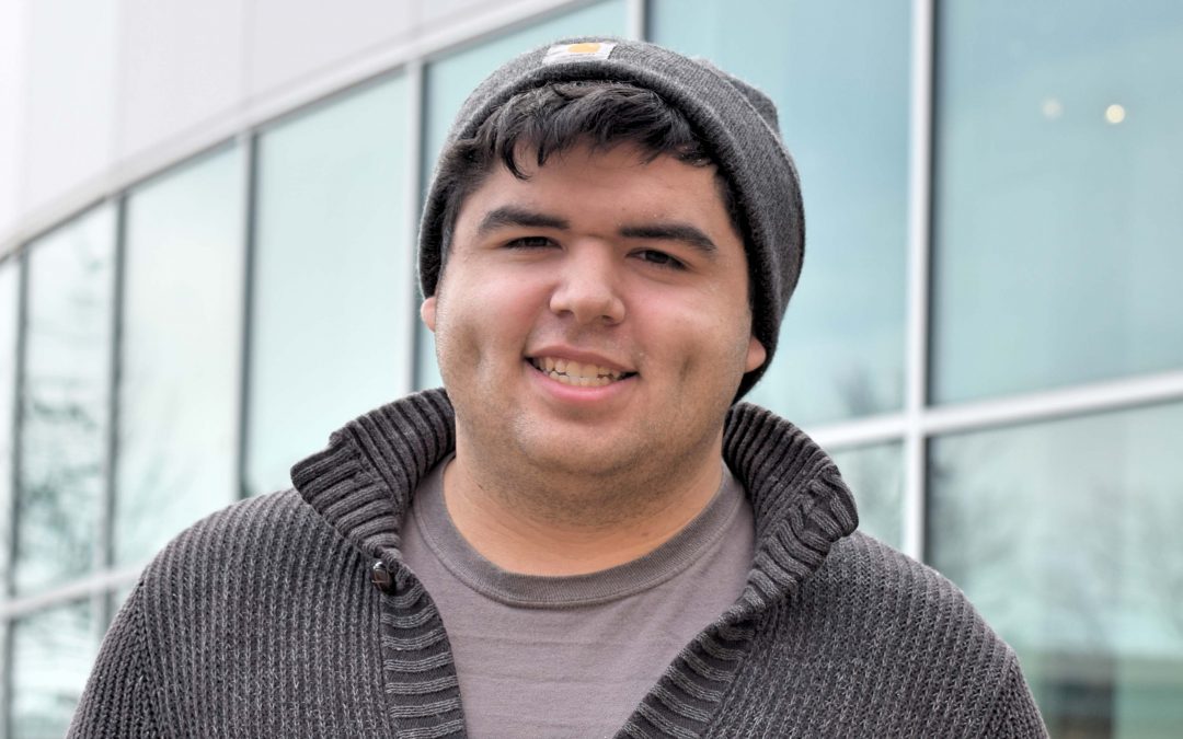 A smiling young dark-haired man