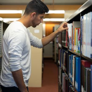 Emmaus student browsing campus library