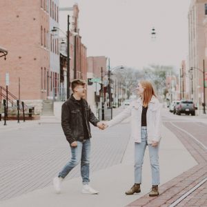Couple standing in city street holding hands