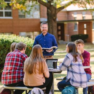 Emmaus students and professor conducting class outside
