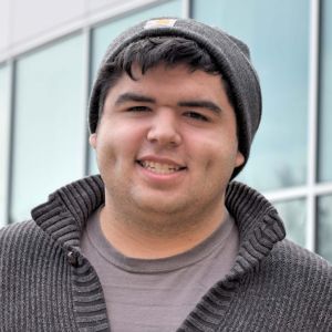 A smiling young dark-haired man