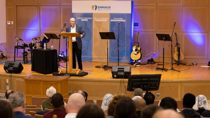 Man Speaking on Stage at Conference